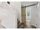 Hallway features hardwood floors, modern finishes, and a sliding barn door at 7141 E Pleasant Run Pkwy S Dr, Indianapolis, IN 46219