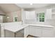 Bright and modern kitchen featuring white cabinetry, stainless steel appliances, and open layout at 7141 E Pleasant Run Pkwy S Dr, Indianapolis, IN 46219