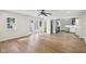 Bright living room featuring hardwood floors, a ceiling fan, and double doors that lead to an outdoor space at 7141 E Pleasant Run Pkwy S Dr, Indianapolis, IN 46219