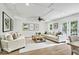 Bright living room with a coffered ceiling, hardwood floors, and neutral-toned furniture at 7141 E Pleasant Run Pkwy S Dr, Indianapolis, IN 46219
