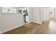 Open concept living space featuring vinyl floors and an opening to a bright kitchen at 7141 E Pleasant Run Pkwy S Dr, Indianapolis, IN 46219