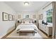 Bright, stylish bedroom with neutral colors, hardwood floors and natural light from windows at 7141 E Pleasant Run Pkwy S Dr, Indianapolis, IN 46219