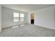 Spacious bedroom with carpeted flooring, two windows, and an adjacent bathroom entrance at 7501 Firecrest Ln, Camby, IN 46113