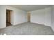 Inviting bedroom features neutral carpet, white walls, and multiple doorways, creating an airy feel at 7501 Firecrest Ln, Camby, IN 46113
