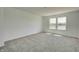 Bright carpeted bedroom featuring neutral tones and a window with pleasant outdoor views at 7501 Firecrest Ln, Camby, IN 46113