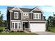 Charming two-story home featuring a two-car garage and a mix of dark siding and brick accents at 7501 Firecrest Ln, Camby, IN 46113