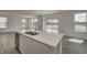 Bright kitchen featuring stainless steel appliances, an island with sink, and sliding door views to the lake at 7501 Firecrest Ln, Camby, IN 46113
