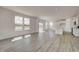 Bright, open-concept living area with large windows and modern flooring, flowing into the kitchen at 7501 Firecrest Ln, Camby, IN 46113
