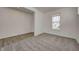 Living room features gray carpet and an entryway, with windows letting in plenty of light at 7501 Firecrest Ln, Camby, IN 46113