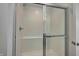 Modern shower featuring subway tile, a built-in seat, and a sleek glass door for a spa-like experience at 7501 Firecrest Ln, Camby, IN 46113