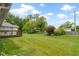 Spacious backyard with lush lawn, landscaping, and mature trees at 786 Woodview North Dr, Carmel, IN 46032
