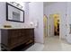 Bathroom with a large vanity, a view into the walk-in closet and glass-enclosed shower at 786 Woodview North Dr, Carmel, IN 46032