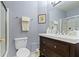 A charming bathroom featuring a dark wood vanity, a toilet, and a glass door shower at 786 Woodview North Dr, Carmel, IN 46032