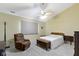 A warm bedroom with neutral carpet, a bed, cozy chair, and ample natural light at 786 Woodview North Dr, Carmel, IN 46032