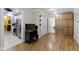 Hallway view featuring stylish wood flooring, storage cabinets, and seamless transition to the kitchen at 786 Woodview North Dr, Carmel, IN 46032