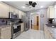 Modern kitchen features stainless steel appliances, granite countertops, tile flooring, and ample cabinet space at 786 Woodview North Dr, Carmel, IN 46032