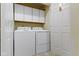 Well-lit laundry room with washer, dryer, and ample storage cabinets at 786 Woodview North Dr, Carmel, IN 46032