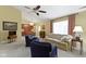 Inviting living room features neutral carpet, vaulted ceilings, ceiling fan, and cozy seating arrangement at 786 Woodview North Dr, Carmel, IN 46032