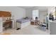 Bright, tidy bedroom featuring a desk, white furniture, and a comfortable bed near a large window at 8038 Midlothian Way, Indianapolis, IN 46214