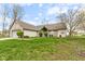 Lovely single-story home featuring brick and vinyl siding, a well-manicured lawn, and mature landscaping at 8038 Midlothian Way, Indianapolis, IN 46214