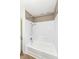 Bathroom featuring a white bathtub with shower, complemented by neutral walls and modern fixtures for a clean and simple design at 823 Rustic Rd, Anderson, IN 46013