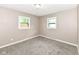 Bright bedroom with neutral paint and plush carpeting at 823 Rustic Rd, Anderson, IN 46013