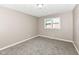 Bedroom with plush carpeting and large window at 823 Rustic Rd, Anderson, IN 46013
