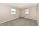 Bedroom featuring plush carpet, two windows, and neutral paint at 823 Rustic Rd, Anderson, IN 46013