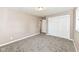 A cozy bedroom featuring neutral walls, plush carpet, and a spacious closet, offering a comfortable retreat at 823 Rustic Rd, Anderson, IN 46013