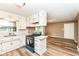 Spacious eat-in kitchen with white cabinets, modern appliances, and stylish faux-wood flooring at 823 Rustic Rd, Anderson, IN 46013