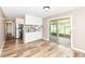 Eat-in kitchen featuring white cabinetry, stainless steel appliances, and a sliding door to an enclosed porch at 823 Rustic Rd, Anderson, IN 46013