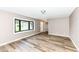 Inviting living room boasts newly installed laminate flooring, neutral paint, and a large picture window at 823 Rustic Rd, Anderson, IN 46013