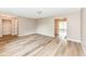 Spacious living room with modern flooring leading to an enclosed sunroom, perfect for relaxation and entertaining at 823 Rustic Rd, Anderson, IN 46013
