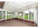 Bright sunroom with windows all around, offering a peaceful view of the backyard and lots of natural light at 823 Rustic Rd, Anderson, IN 46013