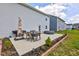 Concrete patio with table, chairs, grill, and hot tub in a green backyard at 853 Woodbridge Way, Lebanon, IN 46052