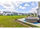 Spacious backyard featuring a hot tub, patio furniture, and ample green space for outdoor enjoyment at 853 Woodbridge Way, Lebanon, IN 46052