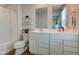 This bright bathroom boasts a double sink vanity, white cabinets, and a plant for decoration at 853 Woodbridge Way, Lebanon, IN 46052