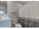 This is a clean bathroom featuring a vanity, toilet, and shower with a gray and white curtain, offering a refreshing space at 853 Woodbridge Way, Lebanon, IN 46052
