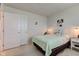 This cozy bedroom is staged with a bed, nightstand, and closet with an open doorway at 853 Woodbridge Way, Lebanon, IN 46052