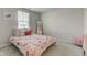 This cozy bedroom has a floral bedspread, a window for natural light, and a large mirror at 853 Woodbridge Way, Lebanon, IN 46052