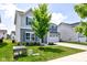 Well-maintained home with a spacious front yard, two-car garage, and charming blue shutters, providing a picturesque setting at 853 Woodbridge Way, Lebanon, IN 46052