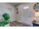 Bright foyer featuring a stylish white door, wood-look flooring, and modern decor, offering a warm welcome into the home at 853 Woodbridge Way, Lebanon, IN 46052