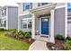 Inviting entrance with a vibrant blue door, complemented by manicured landscaping and a welcoming porch, perfect for guests at 853 Woodbridge Way, Lebanon, IN 46052