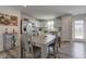 Bright kitchen with white cabinets, stainless steel appliances, and a center dining table at 853 Woodbridge Way, Lebanon, IN 46052