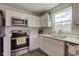 Modern kitchen featuring stainless steel appliances, quartz counters and white cabinetry at 853 Woodbridge Way, Lebanon, IN 46052