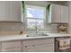 Bright kitchen area featuring quartz countertops, undermount sink and white cabinetry at 853 Woodbridge Way, Lebanon, IN 46052