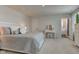 This main bedroom boasts an en-suite bathroom and a vanity with white cabinets and a matching stool at 853 Woodbridge Way, Lebanon, IN 46052