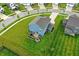 Aerial view of a home with outdoor kitchen and manicured lawn within a peaceful suburban neighborhood at 8547 Winton Pl, Pendleton, IN 46064