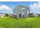 Two-story home with expansive backyard, outdoor dining area, and meticulously landscaped surroundings at 8547 Winton Pl, Pendleton, IN 46064