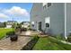 The backyard patio features a built-in grill, outdoor seating, a fire pit and manicured landscaping at 8547 Winton Pl, Pendleton, IN 46064